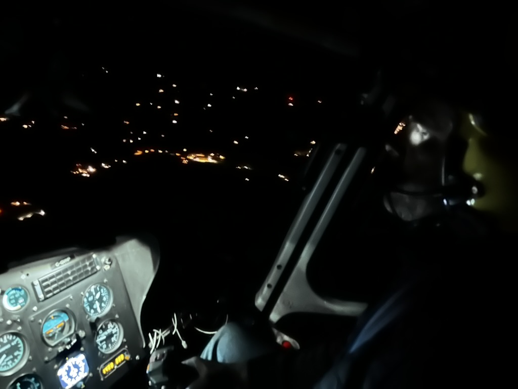 Night cockpit over city lights